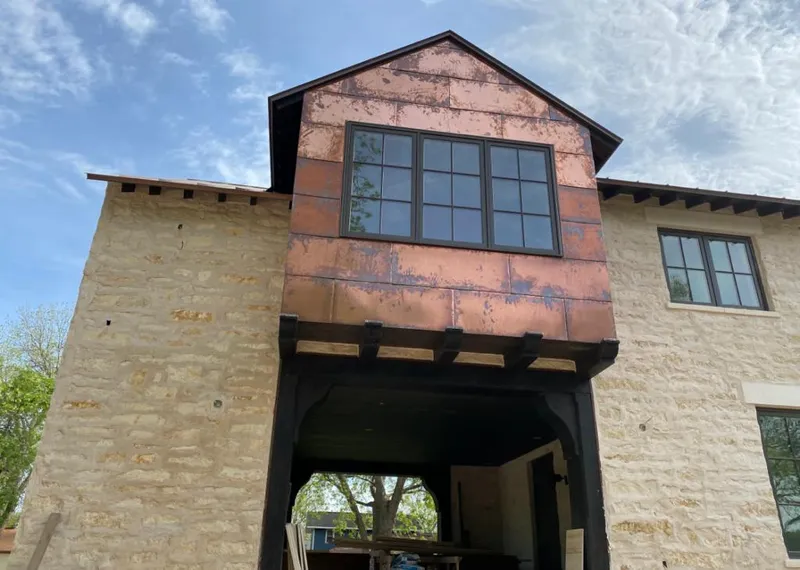 Copper metal panel facade on a stone building for Metal Roof Coating in Golden Valley